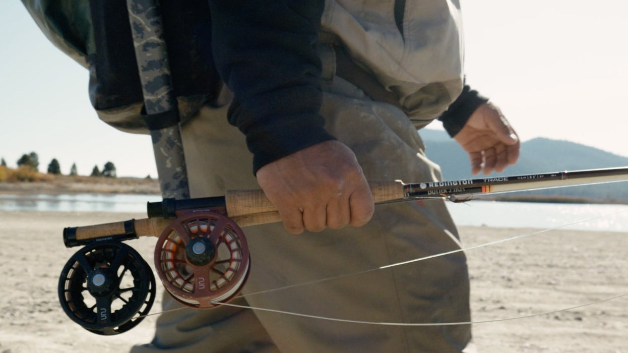 A picture of a Redington Run fly reel in Burgundy on a Redington Trace fly rod