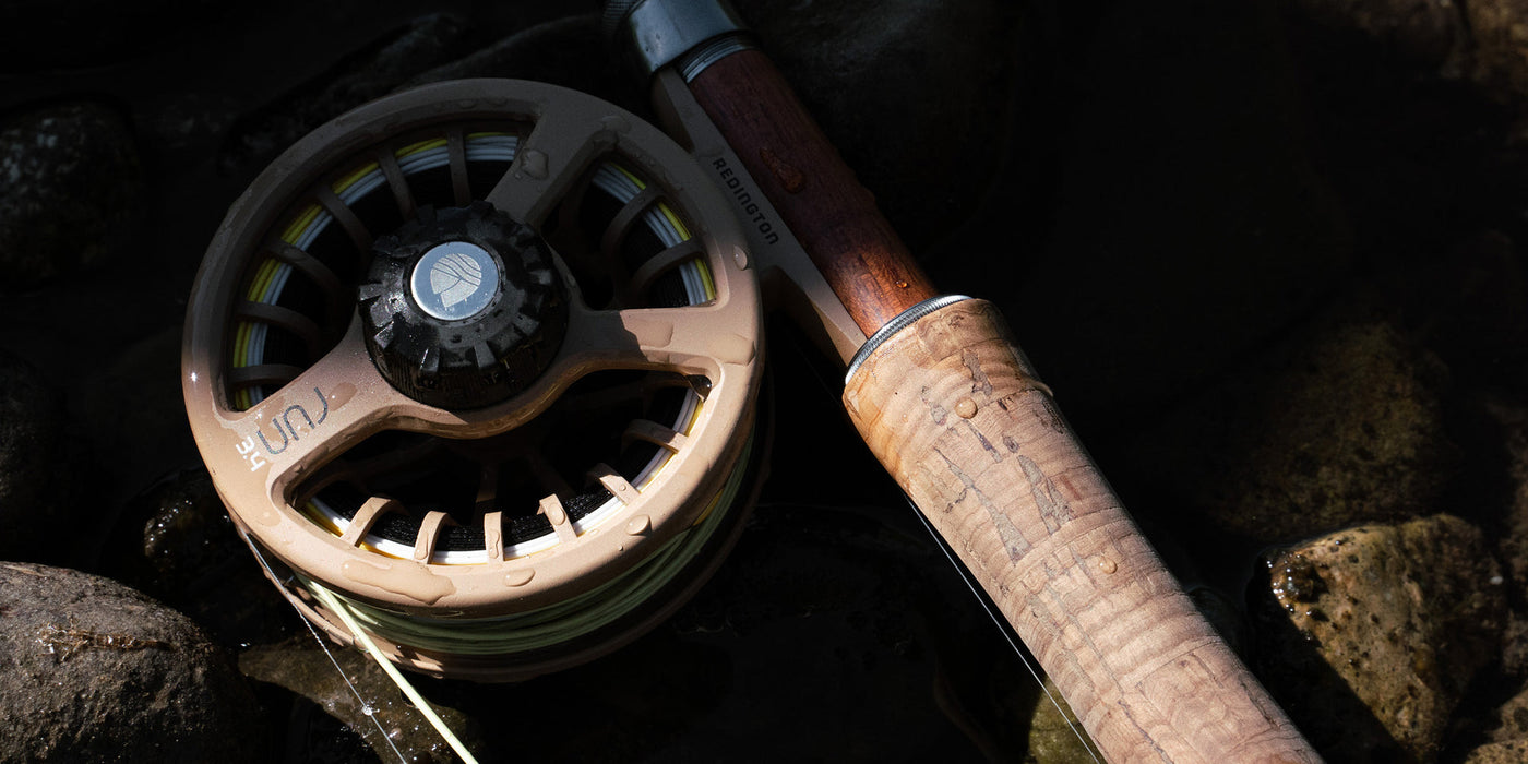 A closeup of a Redington Run fly reel size 3/4 in coyote 