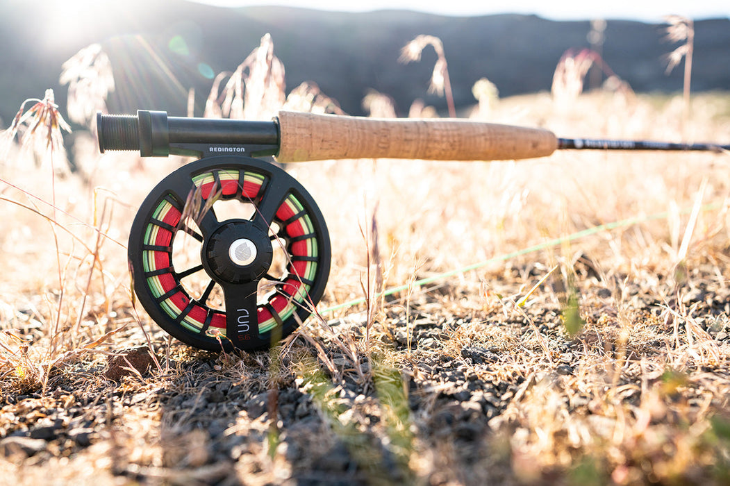 A picture of a Redington Run fly reel in black on an unknown Redington fly rod